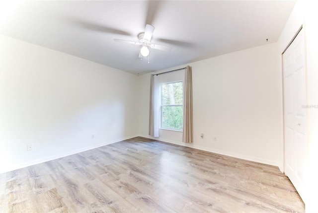 spare room featuring ceiling fan and light hardwood / wood-style flooring