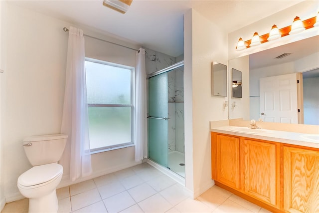 bathroom with an enclosed shower, vanity, toilet, and a wealth of natural light