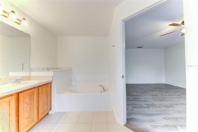 bathroom with a bathing tub, ceiling fan, and vanity