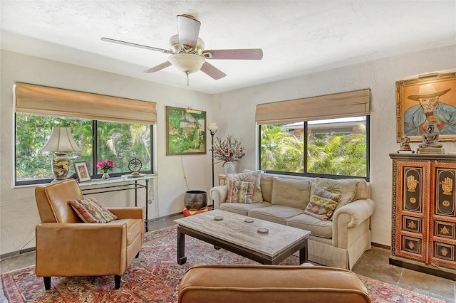 living room with ceiling fan and a wealth of natural light