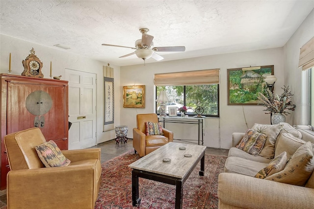 living room with ceiling fan, a textured ceiling, and a wealth of natural light