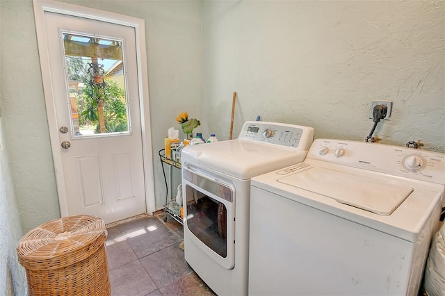 laundry room featuring washer and clothes dryer and tile patterned floors