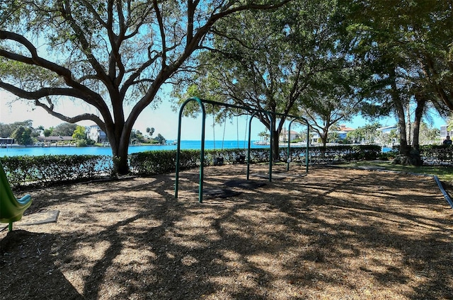 view of property's community featuring a playground and a water view