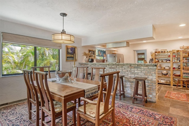 dining room featuring a textured ceiling