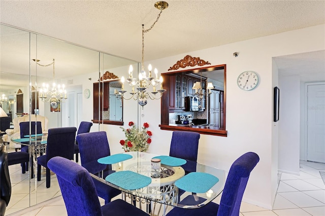 dining area with an inviting chandelier, a textured ceiling, and light tile patterned floors