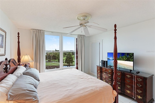 bedroom with ceiling fan and a textured ceiling