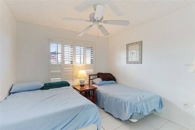 tiled bedroom featuring ceiling fan