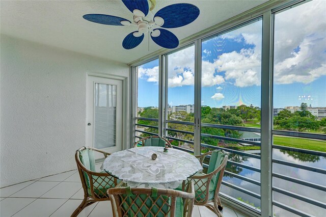 sunroom / solarium featuring ceiling fan