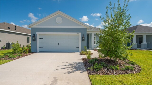 single story home featuring a front lawn, a garage, and central AC unit