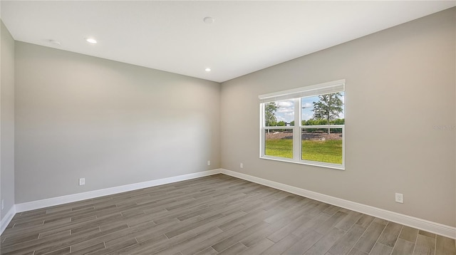 unfurnished room with hardwood / wood-style floors