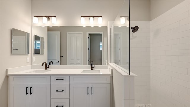 bathroom with vanity and a tile shower