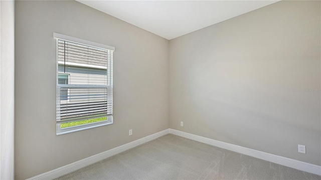 spare room with light colored carpet