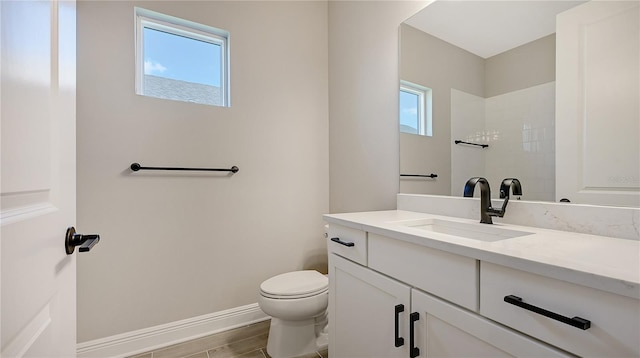 bathroom featuring plenty of natural light, vanity, toilet, and hardwood / wood-style floors