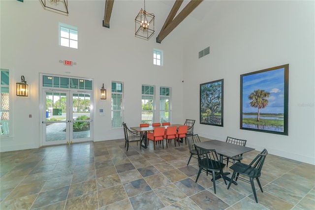 dining space with beam ceiling, french doors, and a notable chandelier