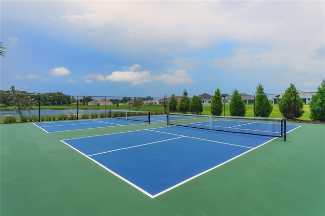 view of tennis court featuring a water view and basketball court