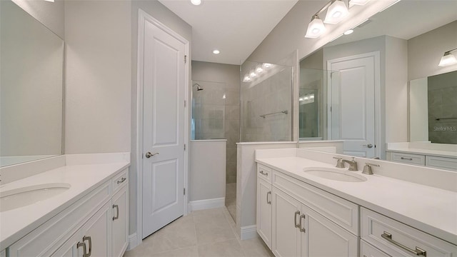 bathroom featuring vanity, tile patterned flooring, and tiled shower