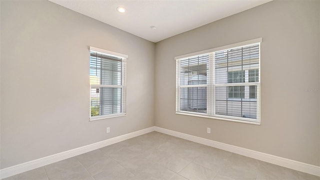 tiled spare room featuring a wealth of natural light