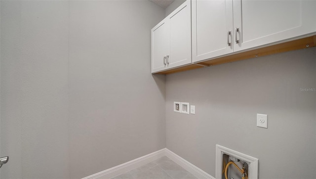 washroom featuring cabinets, hookup for a washing machine, and electric dryer hookup