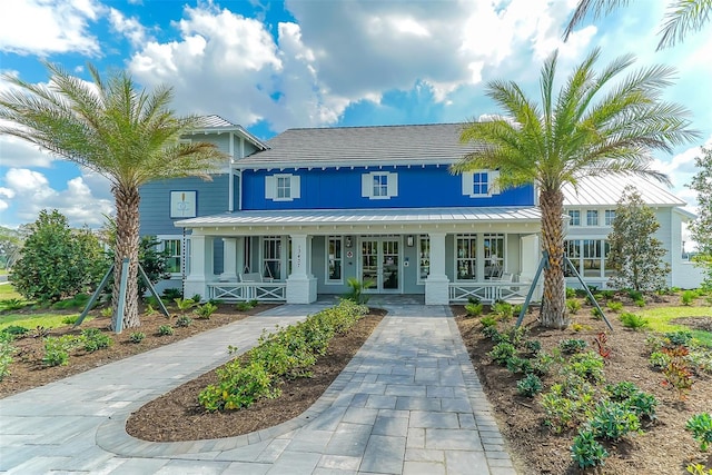 view of front of house with covered porch and french doors