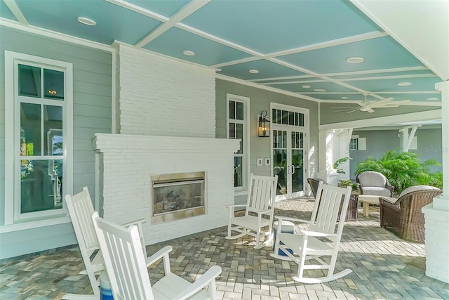 view of patio / terrace with ceiling fan and an outdoor brick fireplace