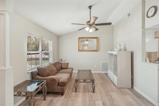 living room with ceiling fan, light hardwood / wood-style floors, and vaulted ceiling