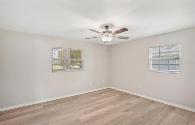 unfurnished room with ceiling fan and light wood-type flooring