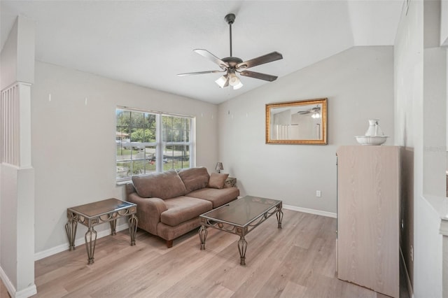 living room with ceiling fan, light hardwood / wood-style flooring, and lofted ceiling