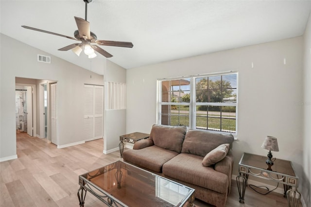 living room featuring ceiling fan, light hardwood / wood-style floors, and vaulted ceiling