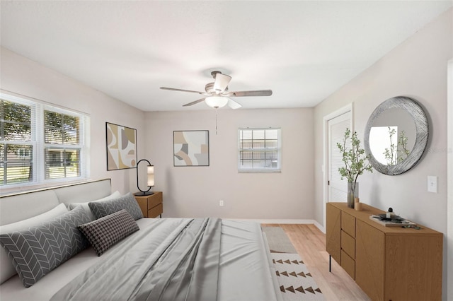 bedroom with ceiling fan and light hardwood / wood-style flooring