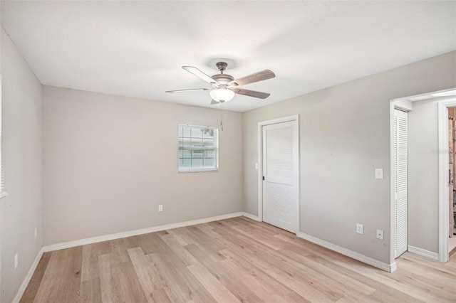 unfurnished bedroom with ceiling fan and light wood-type flooring