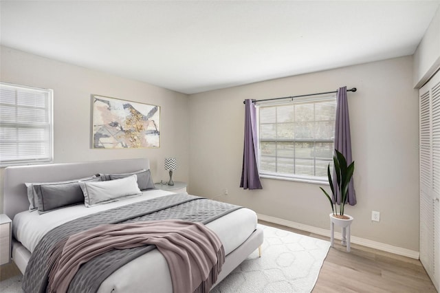 bedroom featuring light hardwood / wood-style flooring and a closet