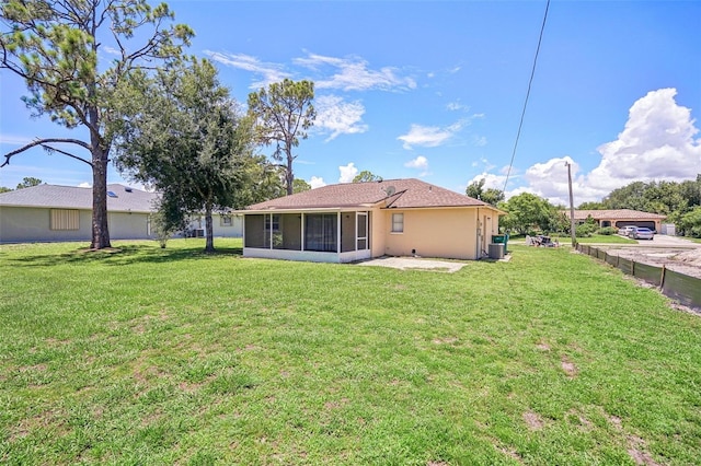 back of property with a sunroom and a yard