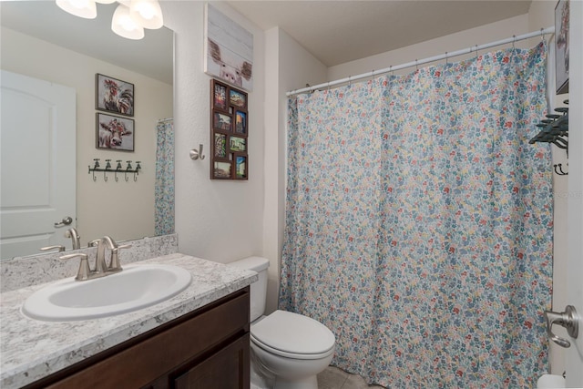 bathroom with tile patterned flooring, vanity, and toilet