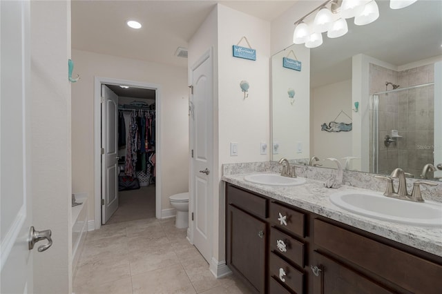 bathroom with walk in shower, tile patterned floors, vanity, and toilet