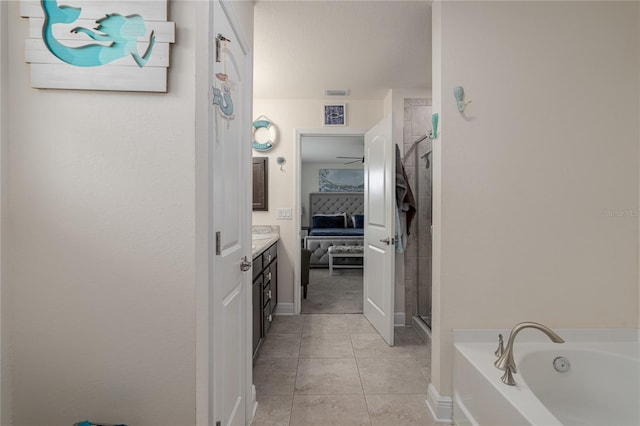 bathroom featuring tile patterned flooring, vanity, and shower with separate bathtub