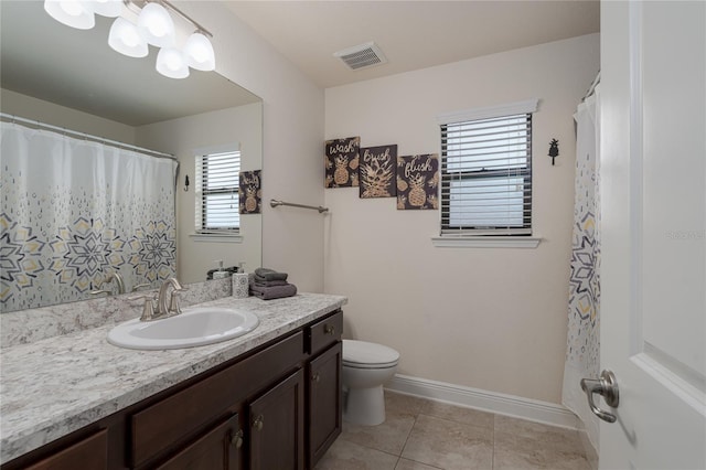 bathroom with vanity, tile patterned flooring, and toilet