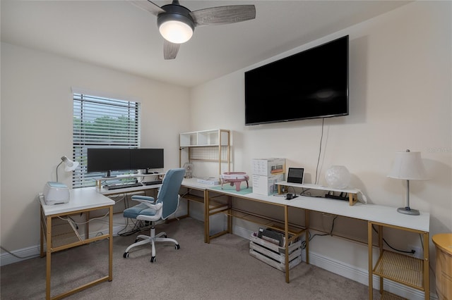 carpeted office space featuring ceiling fan