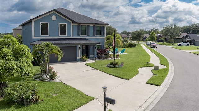 view of front of property with a garage and a front lawn