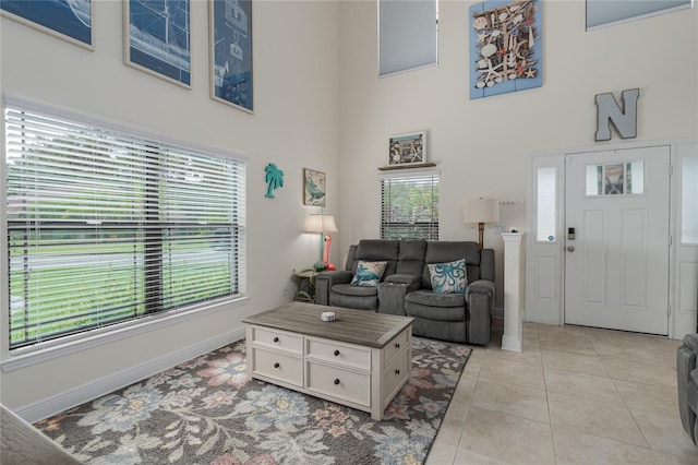 tiled living room with a towering ceiling