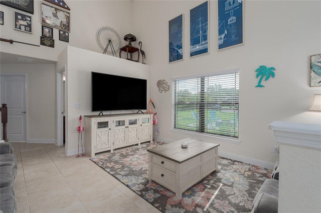 tiled living room with a towering ceiling