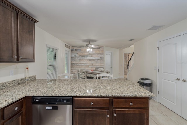 kitchen featuring kitchen peninsula, stainless steel dishwasher, ceiling fan, and light stone countertops