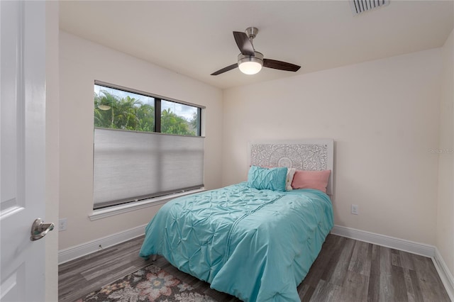 bedroom featuring ceiling fan and dark wood-type flooring