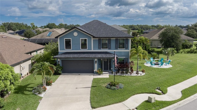 view of front of house featuring a fire pit, a front yard, and a garage