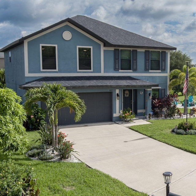 view of front of property featuring a front yard and a garage