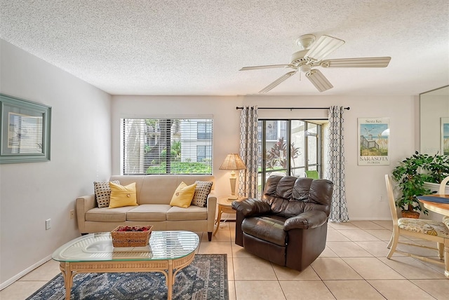 tiled living room featuring a wealth of natural light, a textured ceiling, and ceiling fan