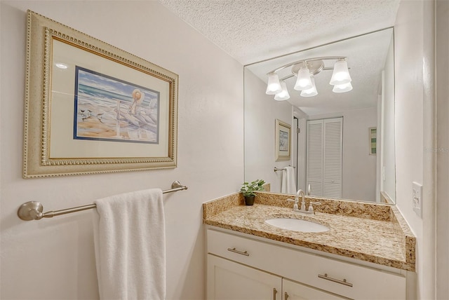 bathroom with vanity and a textured ceiling