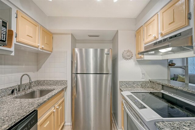 kitchen featuring light brown cabinetry, sink, appliances with stainless steel finishes, and decorative backsplash