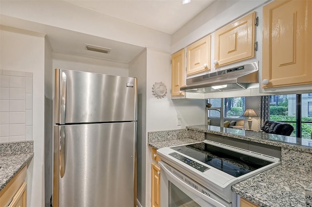 kitchen featuring light brown cabinetry, decorative backsplash, light stone counters, and stainless steel appliances