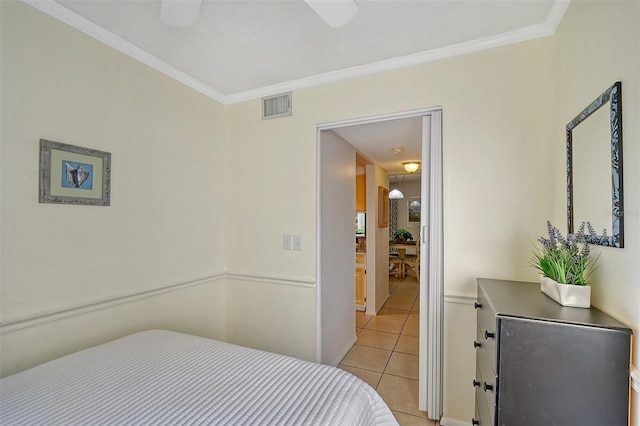 bedroom with crown molding and light tile patterned floors