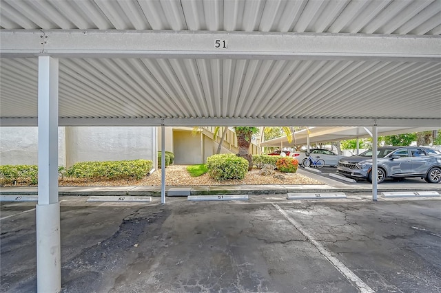 view of parking / parking lot featuring a carport